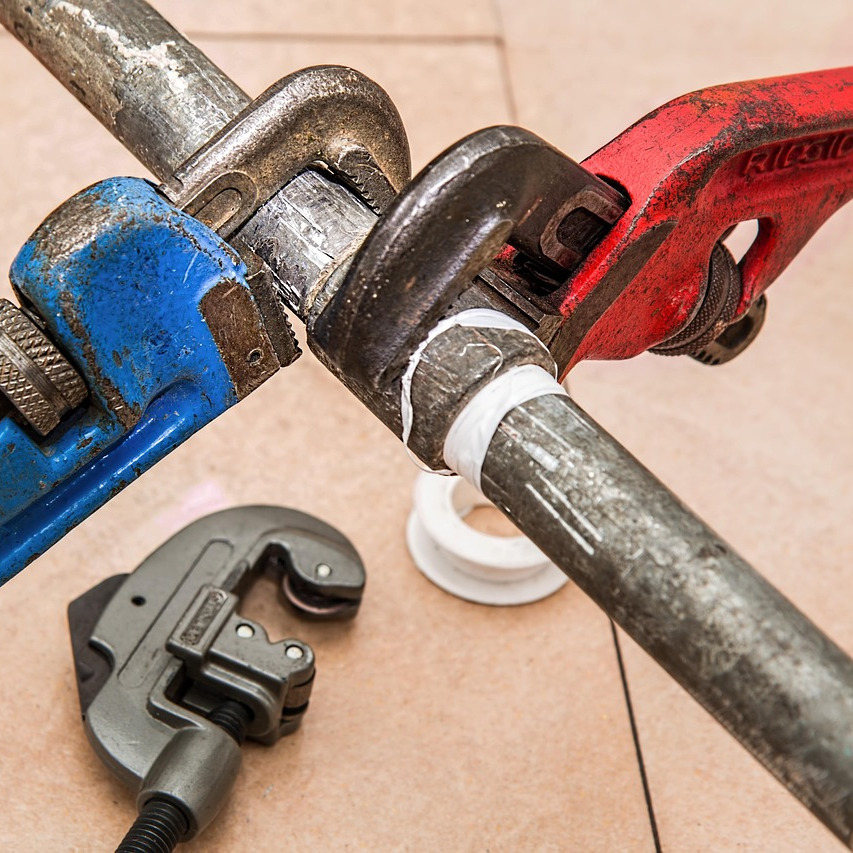 plumber repairing copper pipe